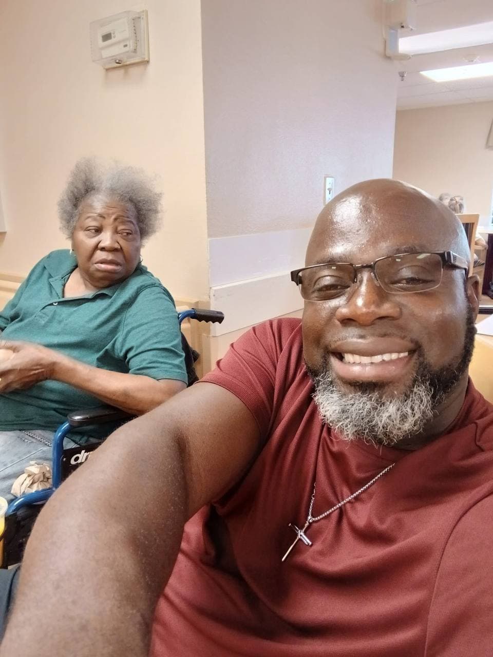 Christianne beside a smiling loved one in a candid selfie.