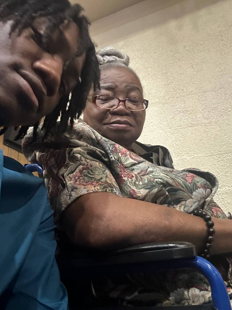 Christianne seated beside a loved one.